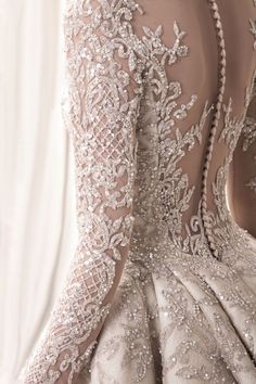 the back of a wedding dress with beading on it