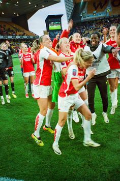 the women's soccer team is celebrating their victory over each other on the field