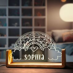 a wooden frame with the word sophia on it in front of a bed