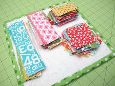 several pieces of fabric laid out on top of a cutting board with scissors and rulers