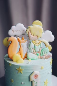 a birthday cake with a boy and a fox on top