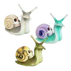 three snails with different colored shells on their backs