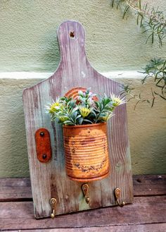 a potted plant sitting on top of a wooden board next to a door handle