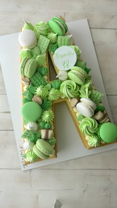 the letter k is decorated with green and white icing