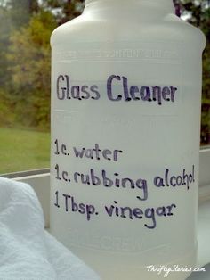 a glass cleaner bottle sitting on top of a window sill