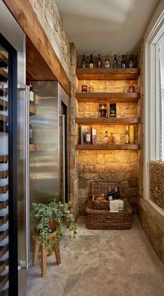 a room with some shelves filled with bottles