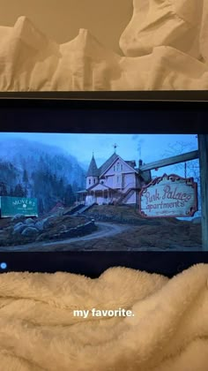 a laptop computer sitting on top of a bed covered in white sheets and blankets next to a sign that says pink palace apartments