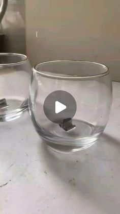 two clear glass bowls sitting on top of a counter