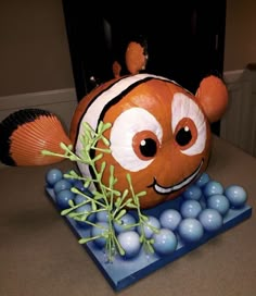 an orange and white clown fish sitting on top of blue balls