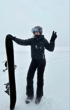 a person standing in the snow with a snowboard attached to their feet and arms