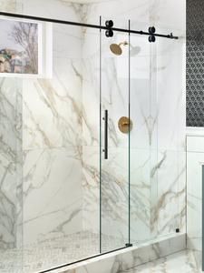 a bathroom with marble walls and flooring next to a walk in shower stall that has glass doors on both sides