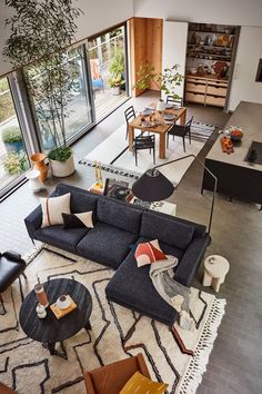 an aerial view of a living room and dining area with furniture in the foreground