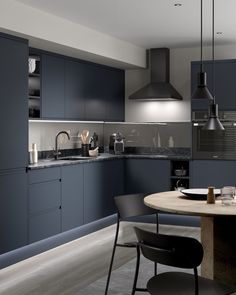 a kitchen with dark blue cabinets and counter tops is seen in this image from the dining room table