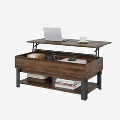 a laptop computer sitting on top of a wooden table next to a shelf with books