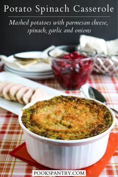 a casserole dish is sitting on a table with other dishes and utensils