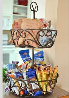 a wire basket filled with snacks on top of a table next to a countertop