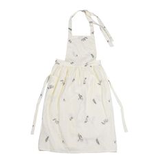 a white apron with birds on it and ties around the neck, hanging from an adjustable strap