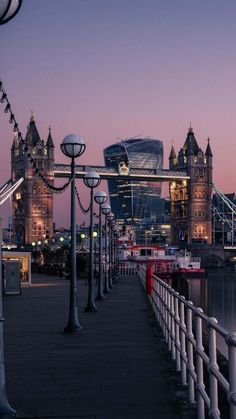 the tower bridge is lit up at night