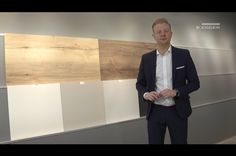 a man standing in front of some white and brown panels