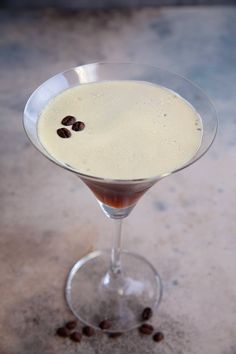 a martini with coffee beans on the rim