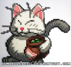 a cross stitch picture of a cat holding a mug