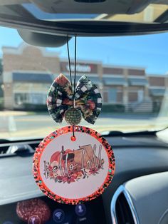 a car dashboard with an ornament hanging from the dash board