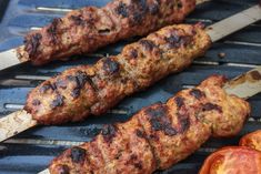 A close up of three koobideh kabobs served with grilled tomatoes. Joojeh Kabob, Persian Beef, Meat Kabobs, Saffron Butter, Iranian Dishes, Grilling Kabobs, Persian Cuisine