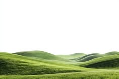 a field with green grass and hills in the background