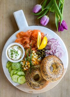 a white plate topped with bagels and vegetables