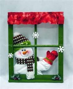 a snowman in a green window with red gloves and mittens