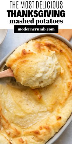 the most delicious thanksgiving mashed potatoes in a pan with a wooden spoon on top