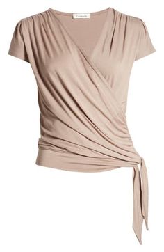 A faux-wrap front flatters on this soft and versatile jersey top cinched with a saucy tie at the hip. 23 1/2" length Surplice V-neck Short sleeves 95% rayon, 5% spandex Machine wash, dry flat Imported Women's Clothing V Neck Tops For Women, Versatile Fitted Short Sleeve Wrap Top, Fitted Beige Wrap Top, Beige Fitted Wrap Top, Faux Wrap V-neck Top, Stretch V-neck Wrap Top For Layering, Apple Body Shapes, Women Blouses Fashion, Wrap Shirt