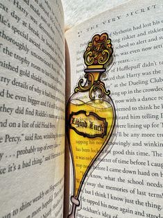 an open book with a glass bottle on it