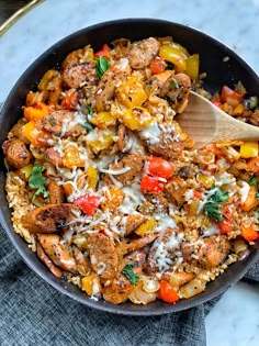 a skillet filled with chicken, rice and vegetables