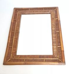 a wooden frame with an intricate design on the front and sides, made out of bamboo