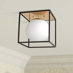 a square light fixture with a white ball hanging from it's center point on the ceiling