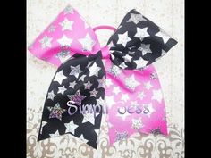 two pink and black bows with silver stars on them