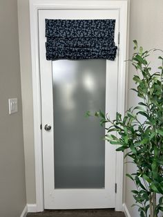 a white door with a blue flowered valance on it