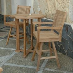 three wooden chairs and a table outside