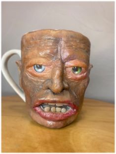 a ceramic mug with a creepy face on it