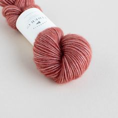 a skein of red yarn sitting on top of a white surface