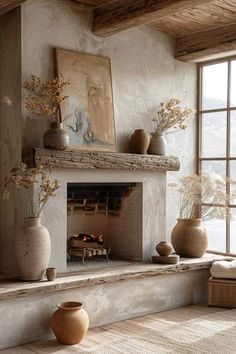 a fireplace with vases on top of it in a living room next to a window