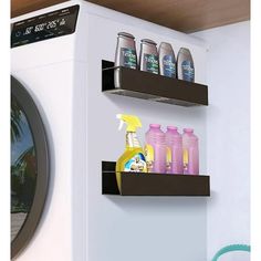 a washer and dryer in a room with two shelves on the wall that hold cleaning products