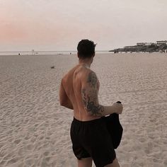 a man standing on top of a sandy beach