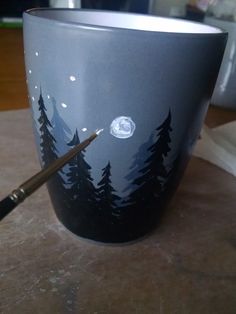 a cup sitting on top of a table next to a brush