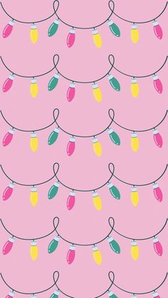 a pink background with colorful lights strung from the top and bottom of each light bulb