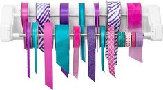 several different colored ties are hanging on a rack with clips attached to the side of it