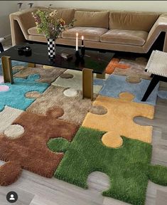 a living room with a couch, coffee table and puzzle pieces rug