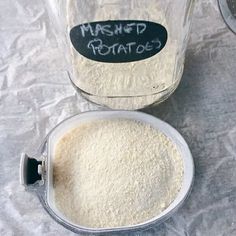 a glass jar filled with white powder next to a measuring cup