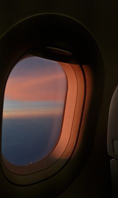 an airplane window looking out at the sky